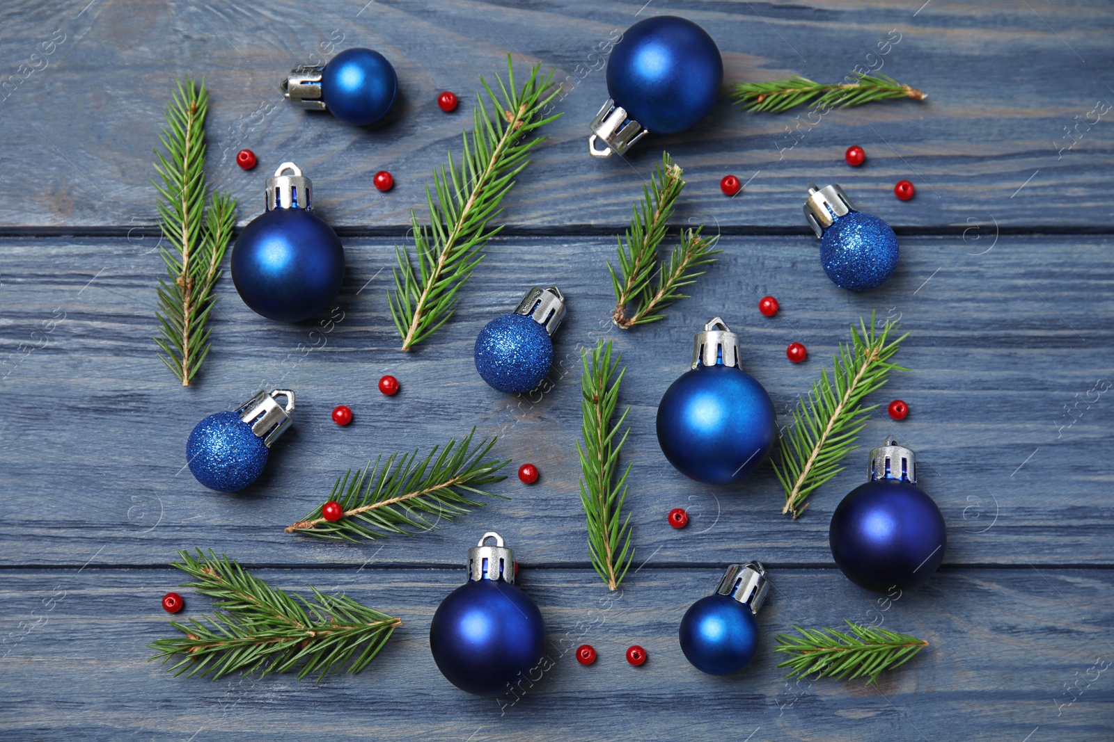 Photo of Flat lay composition with Christmas decor on blue wooden background