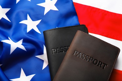 Passports in leather covers on flag of USA, top view