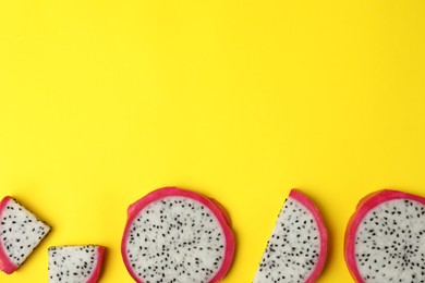 Photo of Delicious sliced dragon fruit (pitahaya) on yellow background, flat lay. Space for text