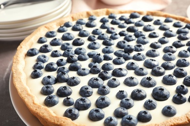 Photo of Plate with tasty blueberry cake on table