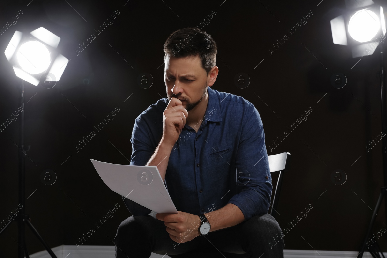 Photo of Professional actor reading his script during rehearsal in theatre