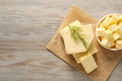 Tasty butter with dill on wooden table, top view. Space for text