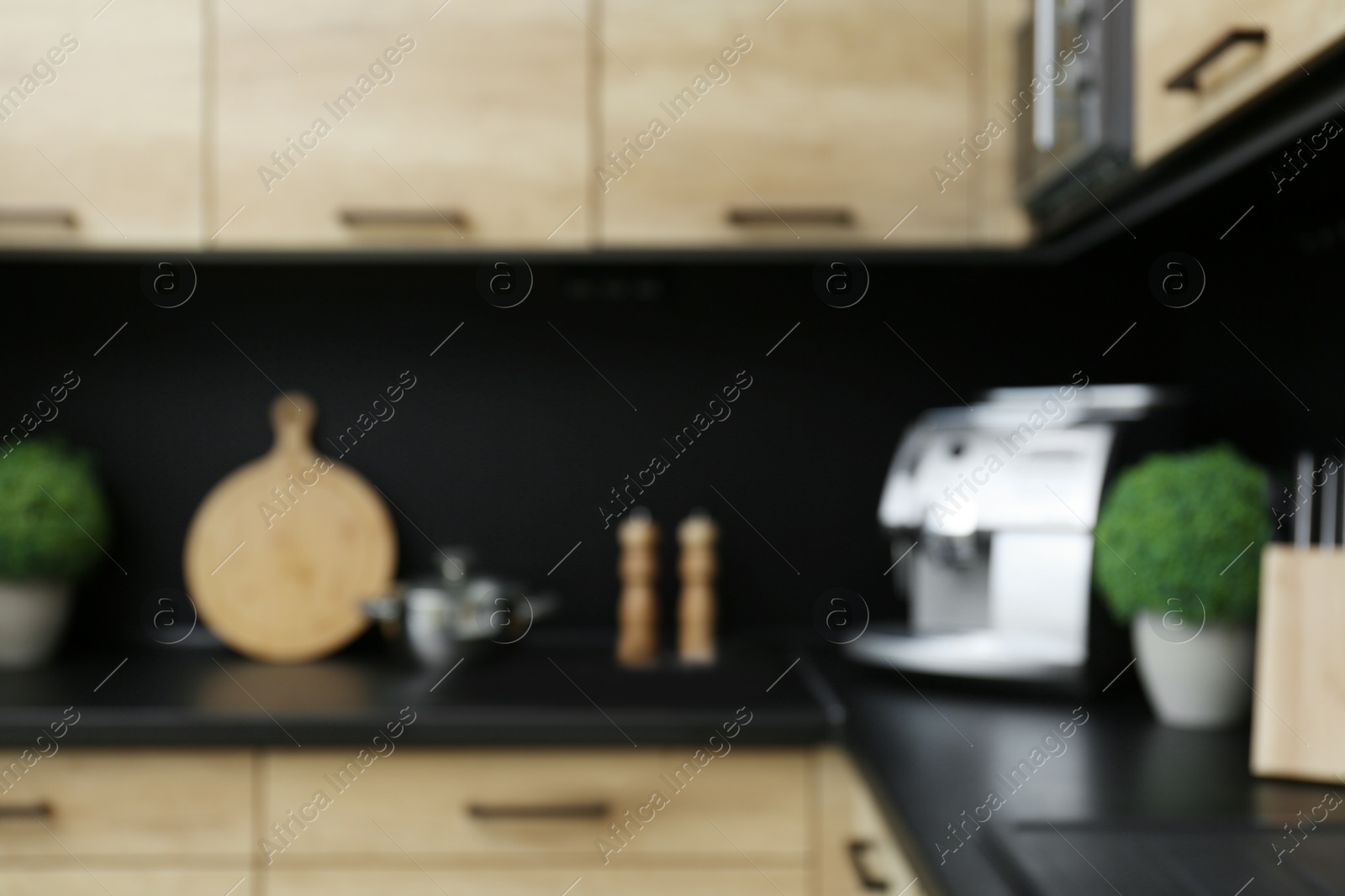 Photo of Blurred view of kitchen interior with modern furniture