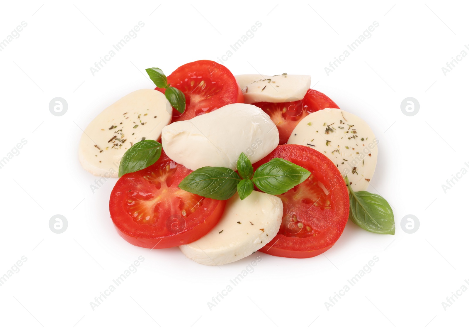 Photo of Delicious Caprese salad with tomatoes, mozzarella cheese, basil leaves and herbs isolated on white