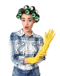 Photo of Funny young housewife with hair rollers and rubber gloves on white background