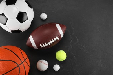 Many different sports balls on dark gray background, flat lay. Space for text