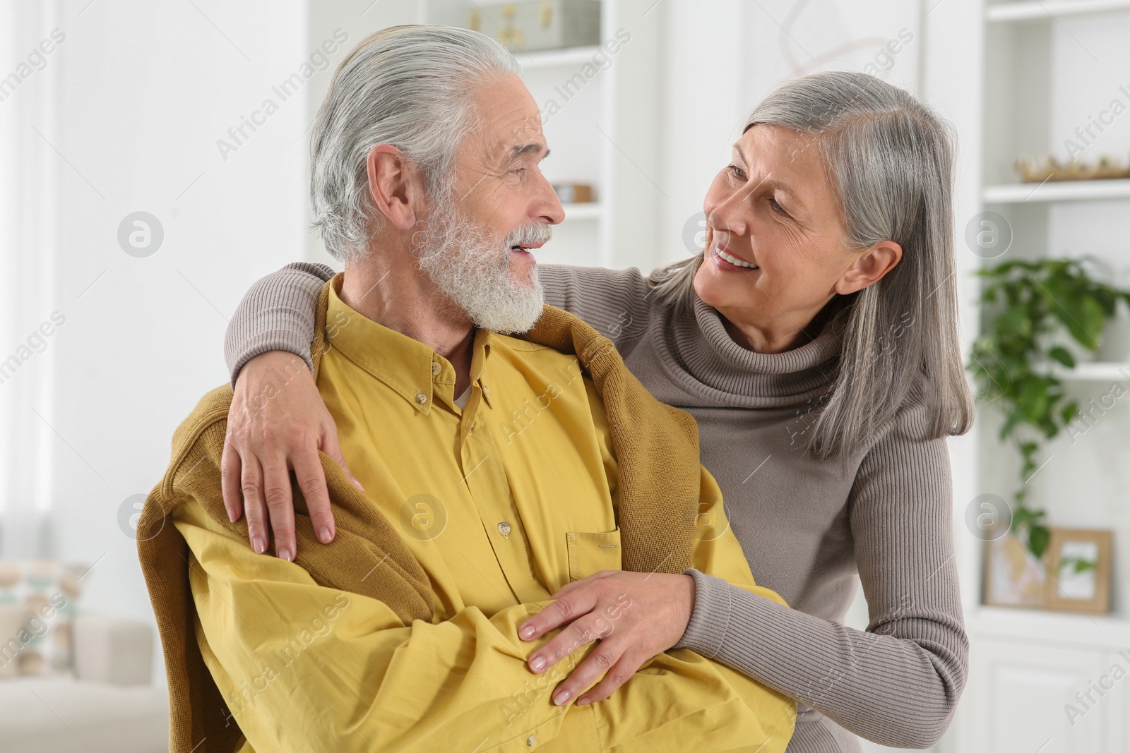 Photo of Portrait of affectionate senior couple at home