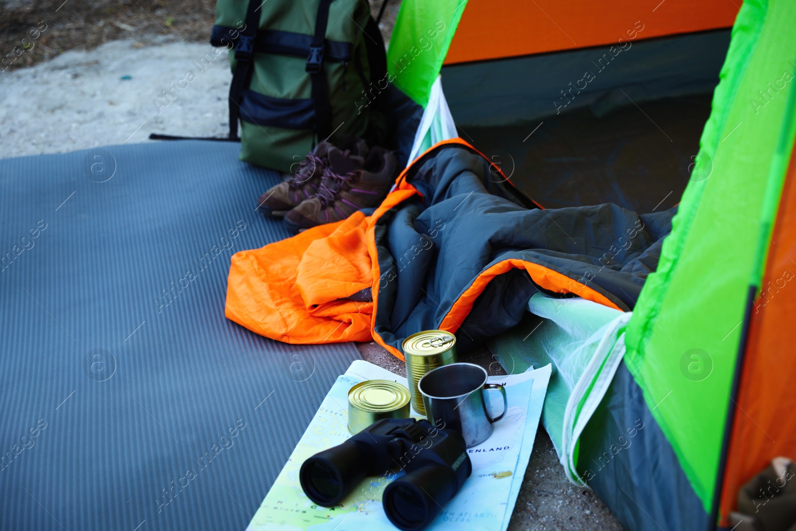 Photo of Sleeping bag and other camping gear outdoors