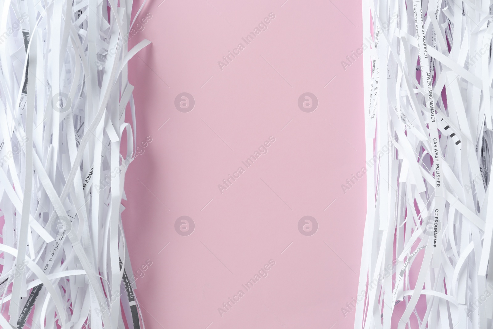 Photo of Shredded paper strips on violet background, flat lay. Space for text