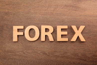 Photo of Word Forex made of letters on wooden table, top view