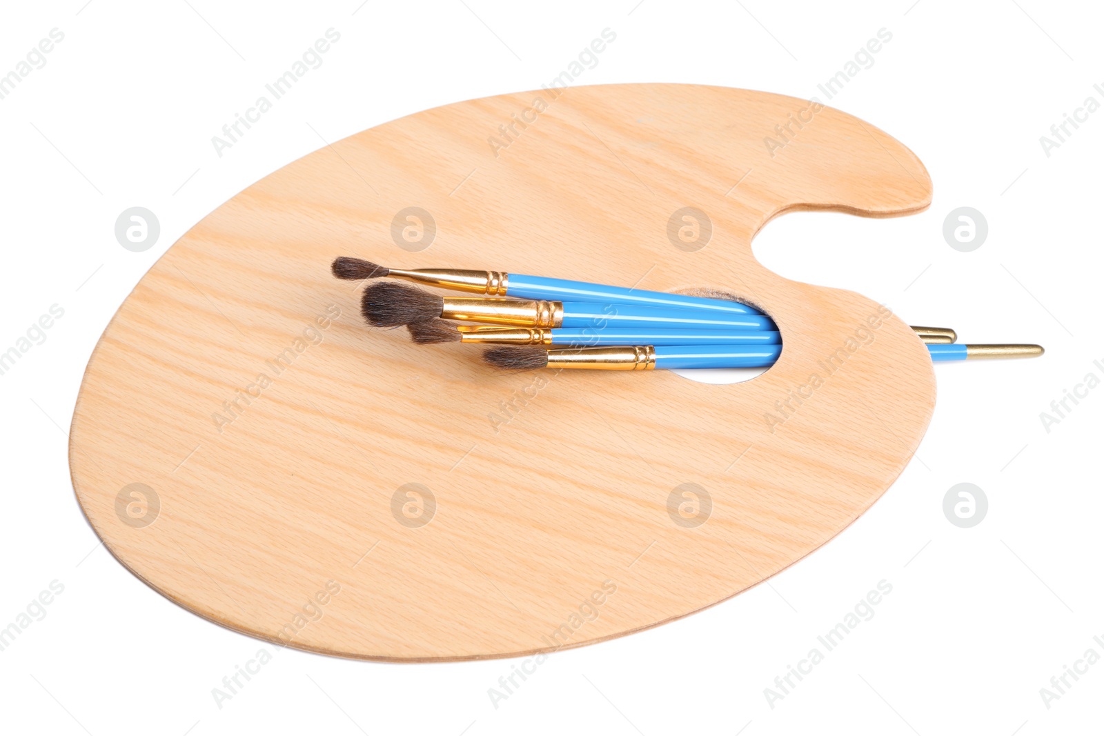 Photo of New wooden paint palette with different brushes on white background