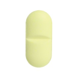 One light green pill on white background. Medicinal treatment
