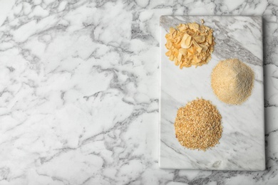 Flat lay composition with garlic products on marble background