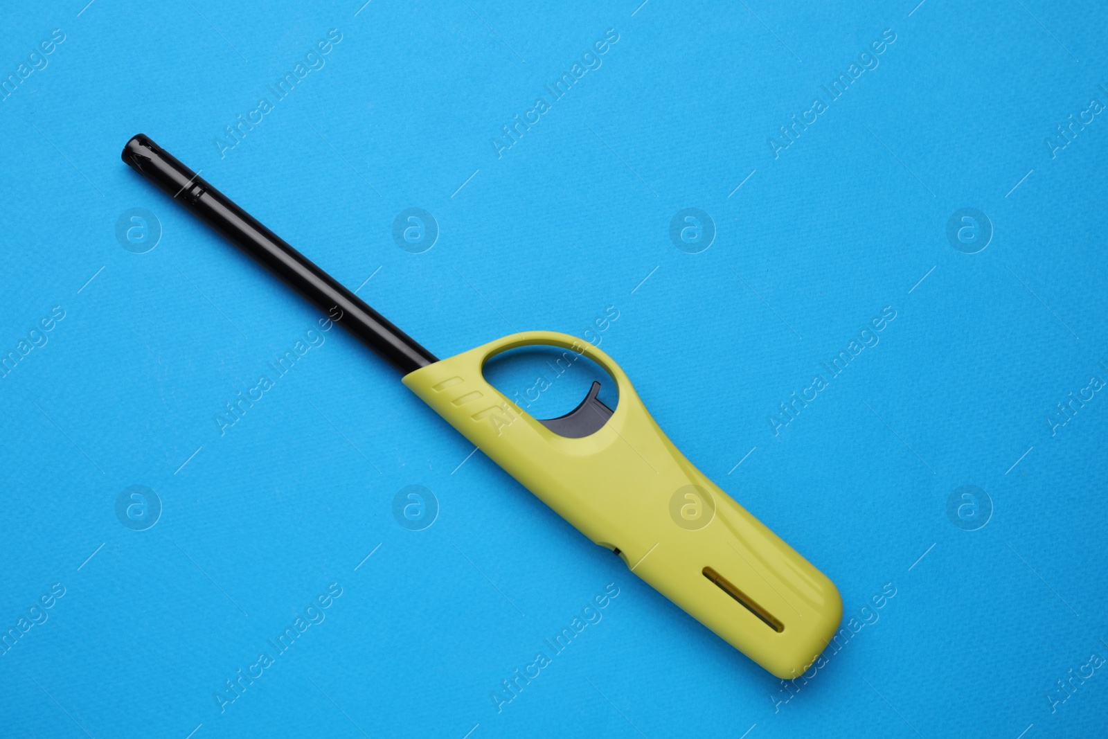 Photo of One gas lighter on blue background, top view