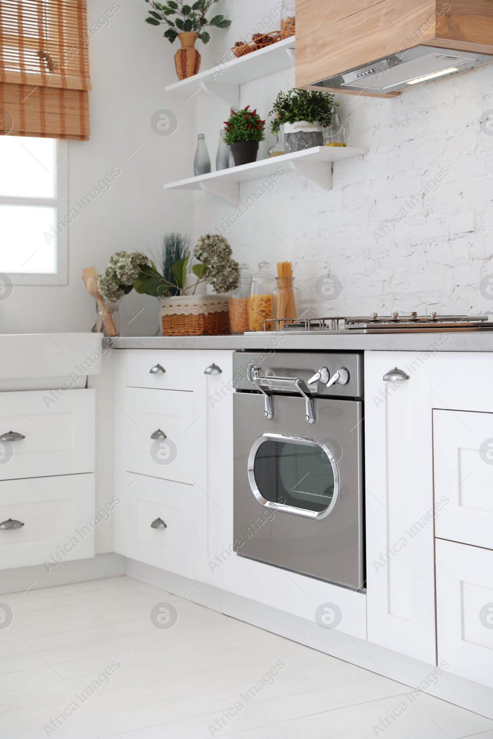 Photo of New modern oven in stylish kitchen. Cooking appliance