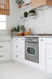 Photo of New modern oven in stylish kitchen. Cooking appliance