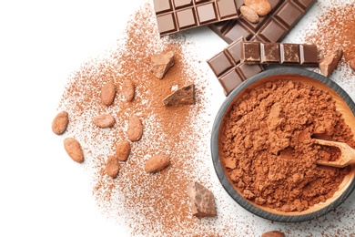Photo of Flat lay composition with cocoa powder, beans and chocolate on light background