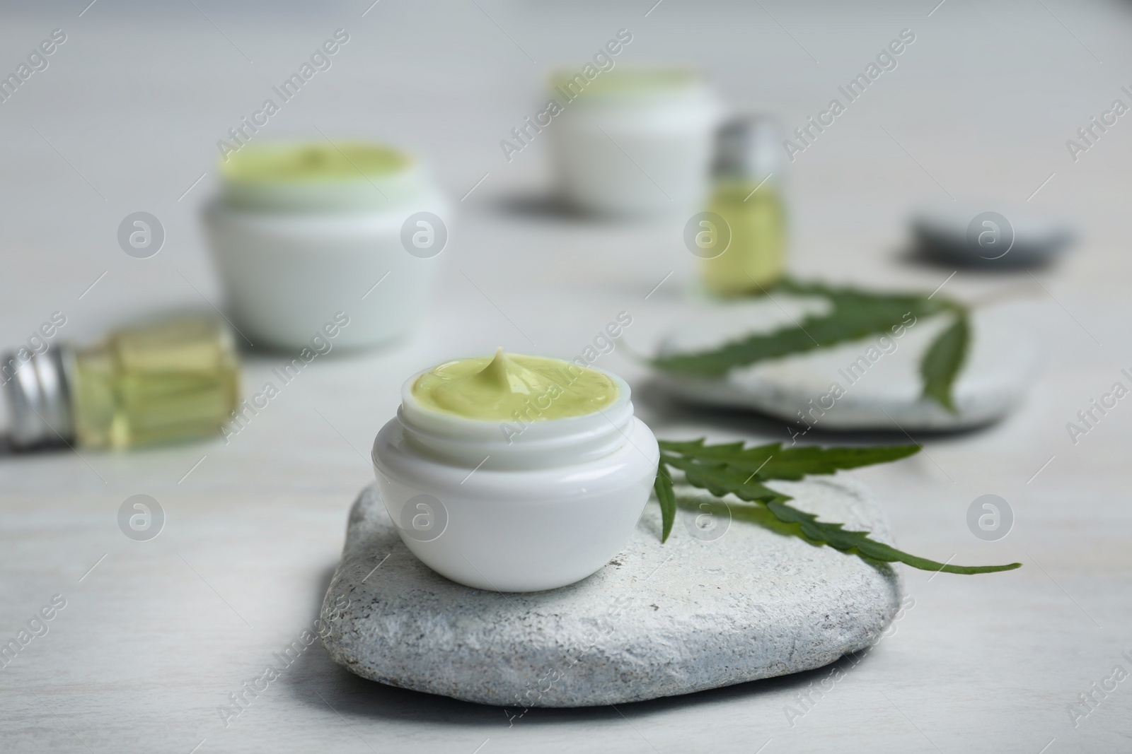 Photo of Jar of moisturizing hemp lotion on table