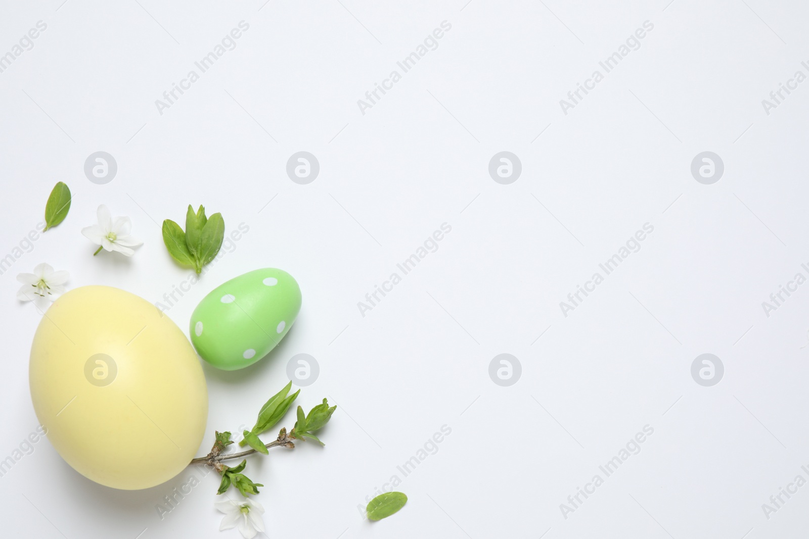 Photo of Flat lay composition with Easter eggs on white background. Space for text