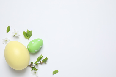 Flat lay composition with Easter eggs on white background. Space for text