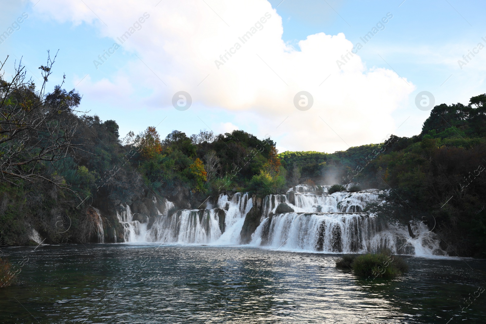 Photo of Picturesque view of beautiful waterfall and rocks outdoors