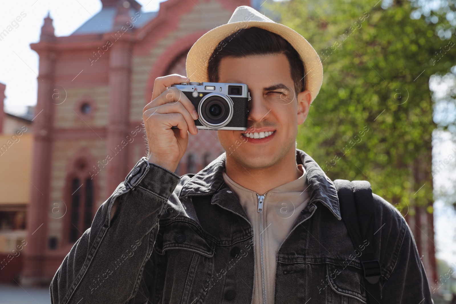 Photo of Tourist taking picture on beautiful city street