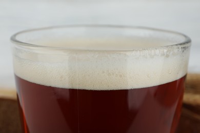 Photo of Glass of delicious kvass on blurred background, closeup
