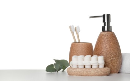 Photo of Bath accessories. Different personal care products and eucalyptus branch on table against white background. Space for text