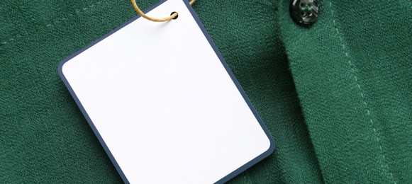 Blank tag on green shirt, top view with space for text. Banner design