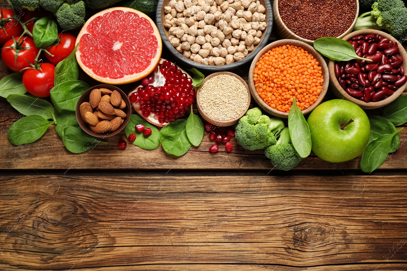 Photo of Fresh vegetables, fruits and seeds on wooden table, flat lay. Space for text