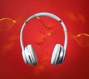 Image of Modern headphones and illustration of dynamic sound waves on red background