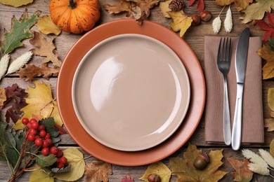 Photo of Festive table setting with autumn decor on wooden background, flat lay
