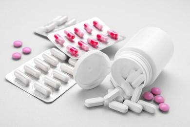 Different antidepressants and medical bottle on grey background