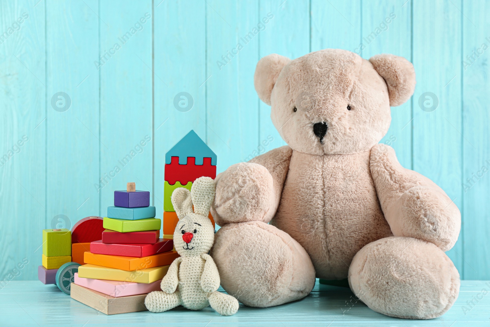 Photo of Set of different toys on light blue wooden table