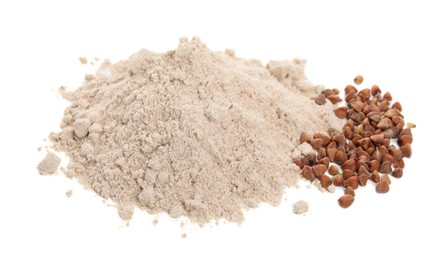 Photo of Pile of buckwheat flour and grains isolated on white