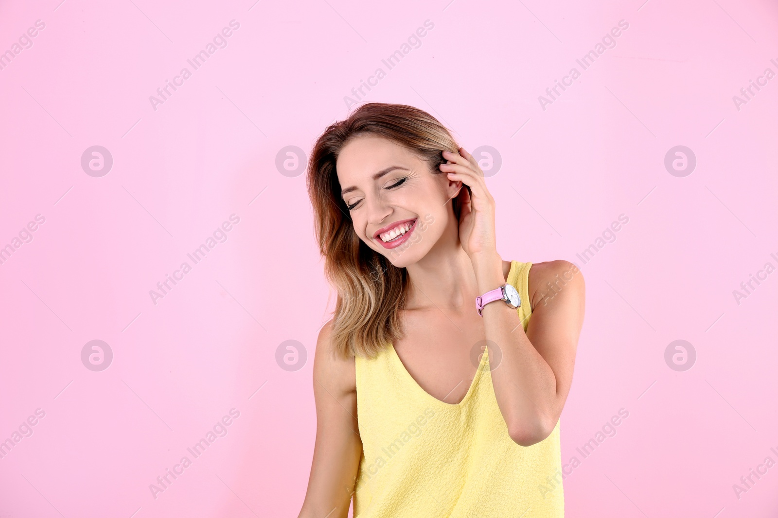 Photo of Portrait of beautiful laughing woman on color background