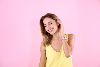 Portrait of beautiful laughing woman on color background