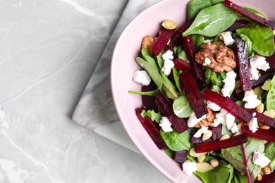 Delicious beet salad served on grey marble table, top view. Space for text