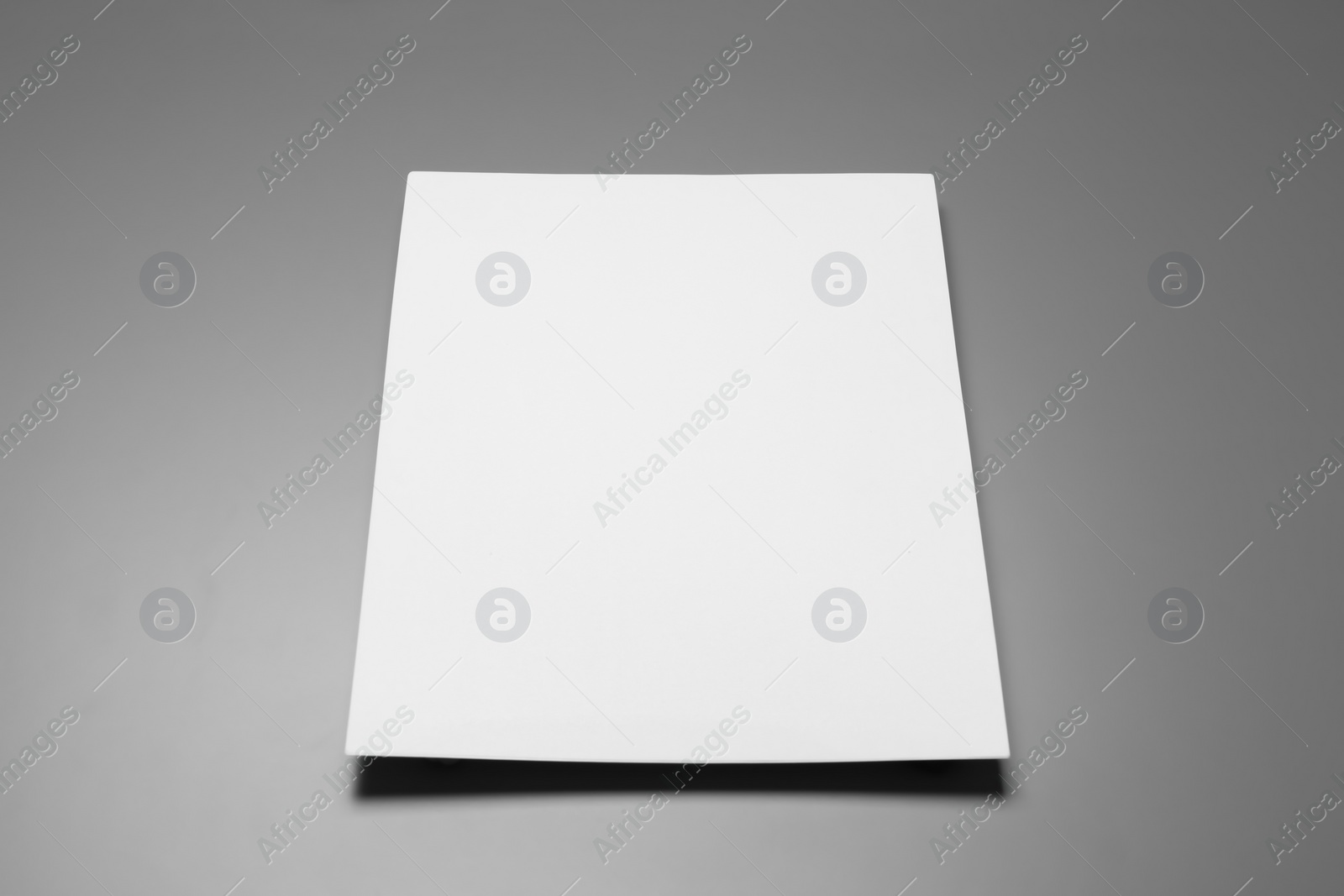 Photo of Blank paper sheets for brochure on grey background. Mock up