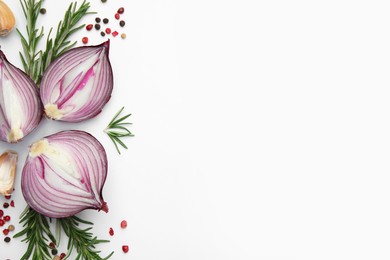 Fresh red onions, garlic, rosemary and spices on white background, flat lay. Space for text