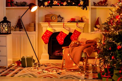 Photo of Living room interior with fireplace, armchair and Christmas decor