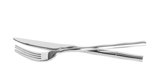 Knife and fork isolated on white. Stylish shiny cutlery set