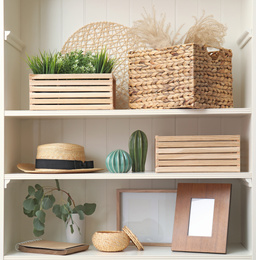 White shelving unit with plants and different decorative stuff