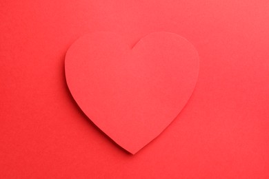 Photo of One paper heart on red background, top view