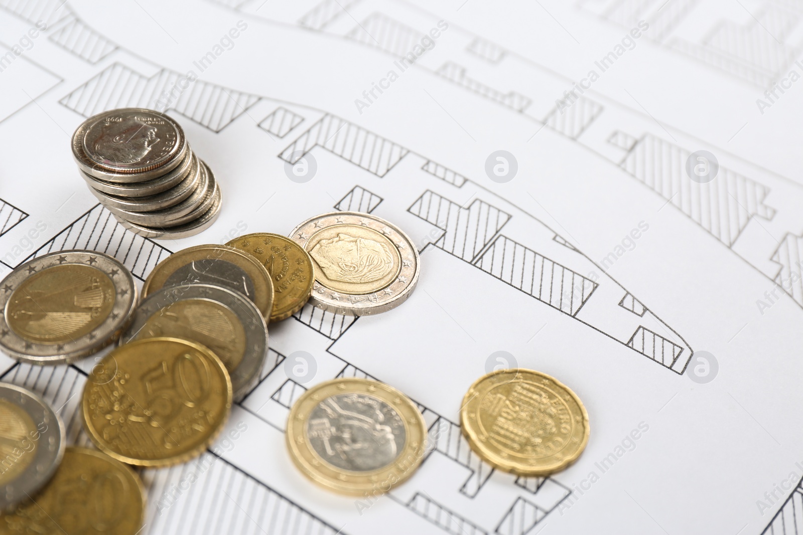 Photo of Coins on cadastral map of territory with buildings, closeup