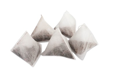 Photo of Many new pyramid tea bags on white background