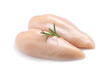 Raw chicken breasts with rosemary on white background