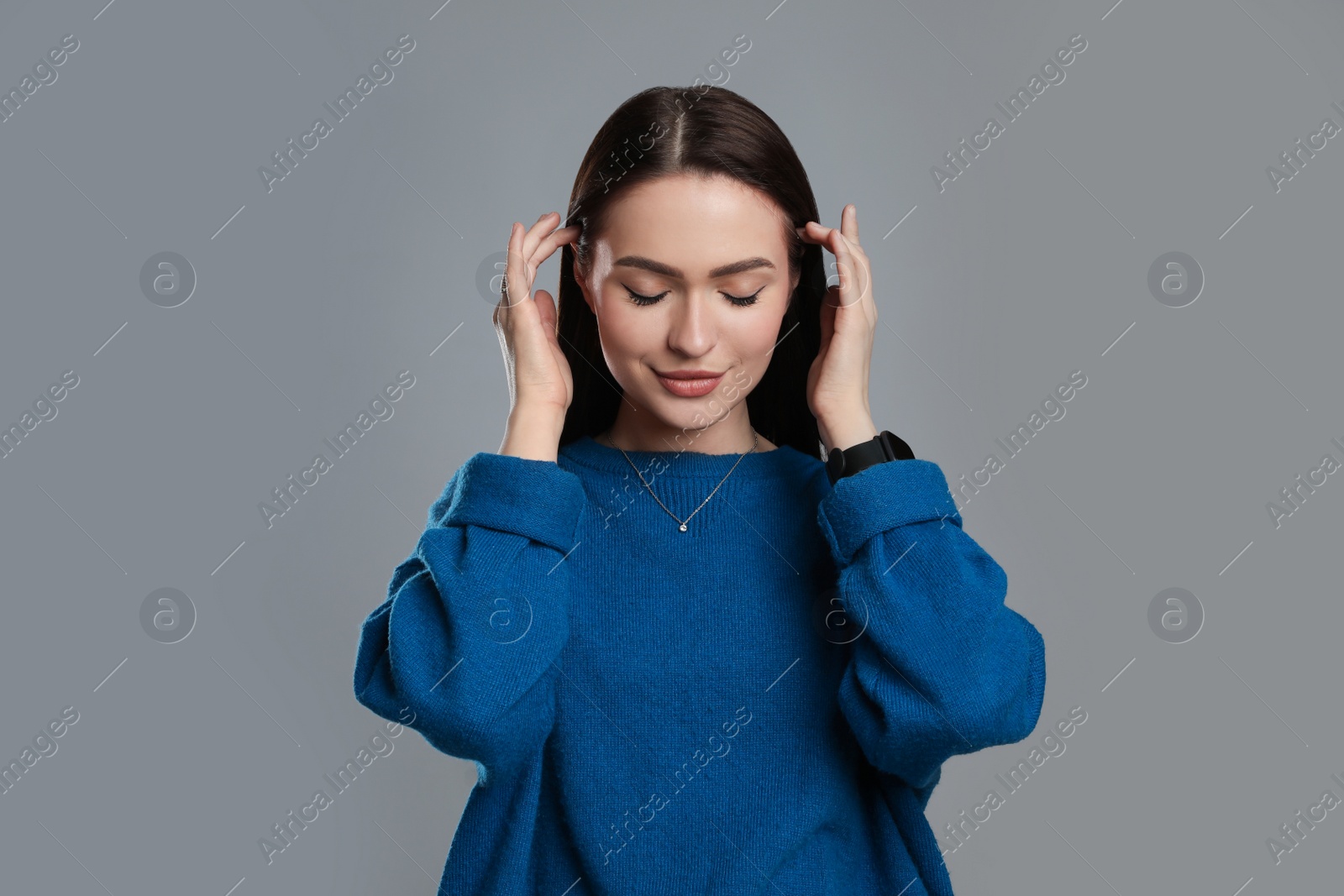 Photo of Portrait of beautiful young woman on grey background