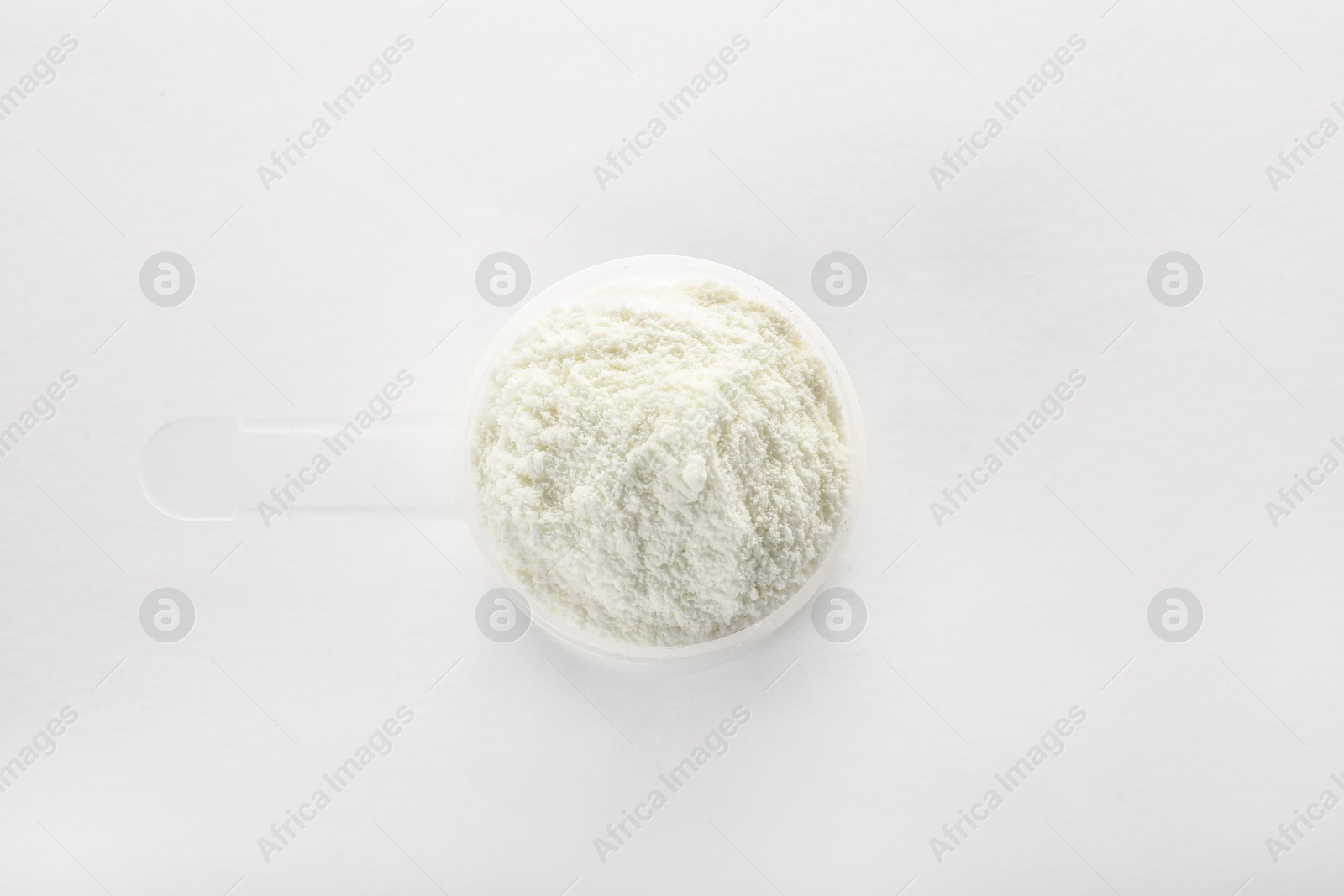 Photo of Scoop of protein powder on white background, top view