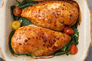 Photo of Baked chicken fillets with vegetables and marinade on table